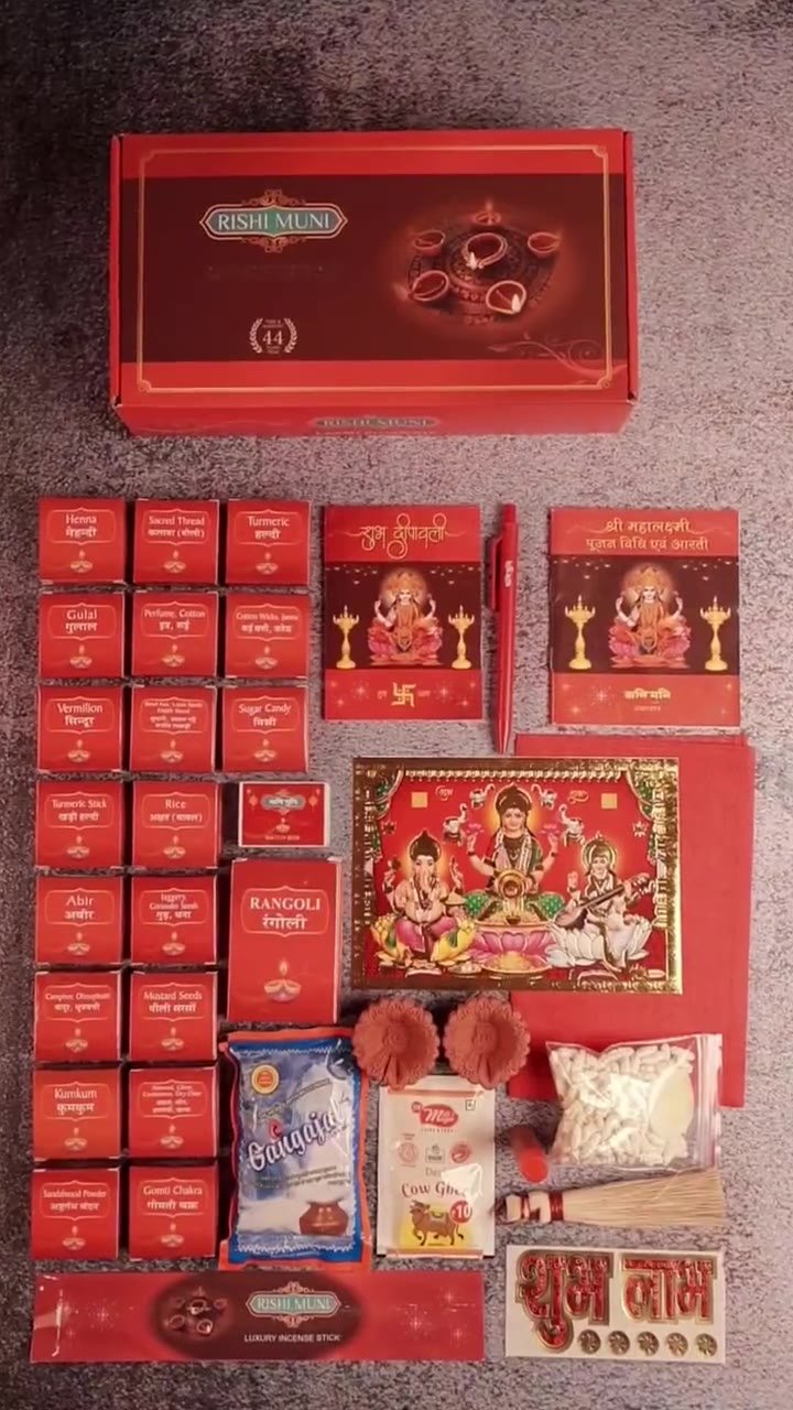 All 44 items of the Rishi Muni Laxmi Pujan Kit laid out: labelled red packets, Lakshmi-Ganesh paana, clay diyas, gangajal, ghee, jhaadu and Shubh Labh